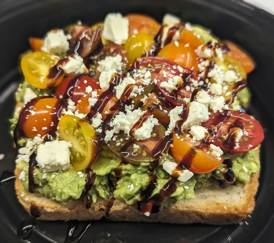 Loaded avocado toast with tomatoes, feta, and balsamic glaze at HT's Sand Bar & Bistro