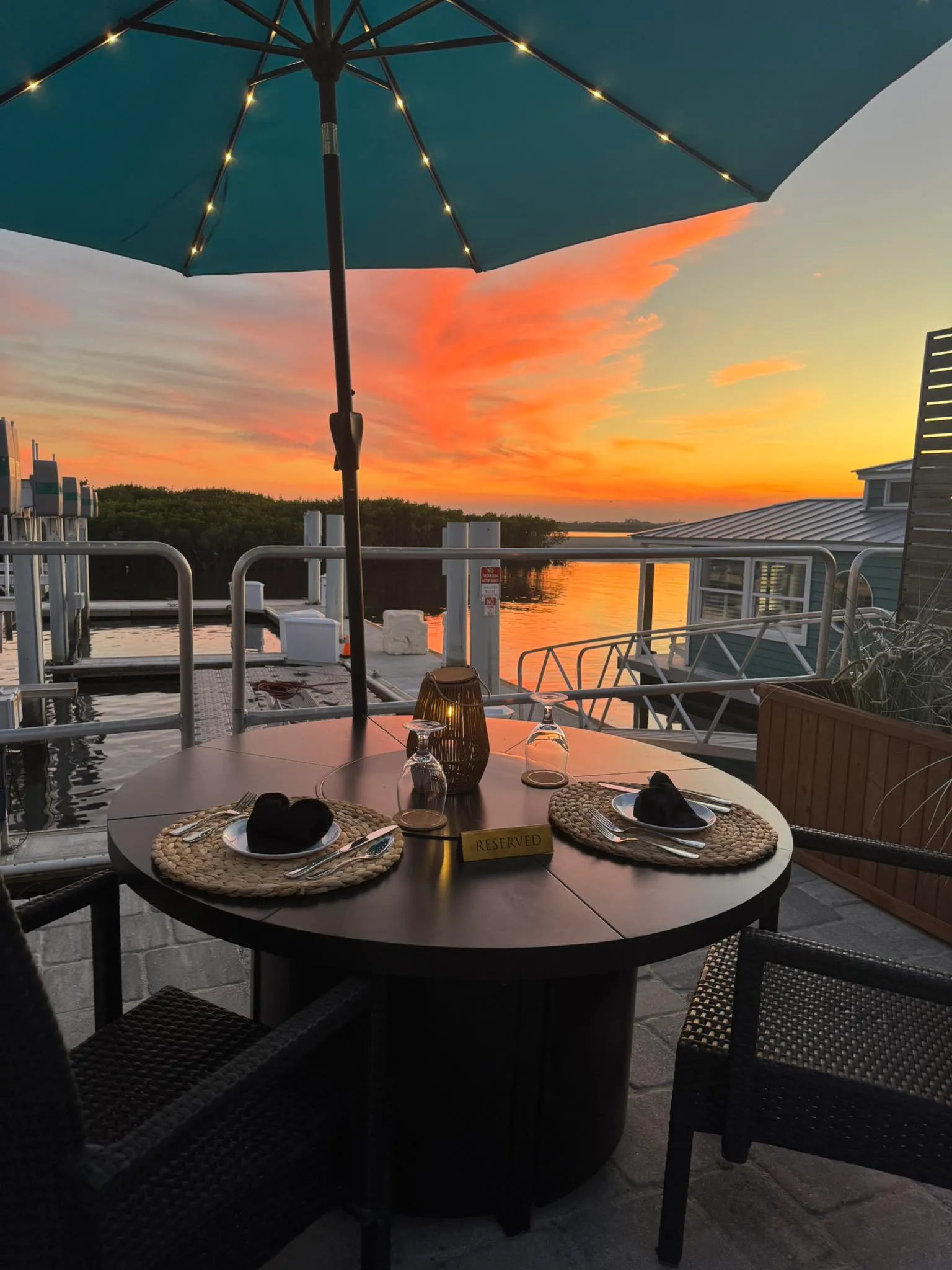 Reserved waterfront table at sunset at HT's Sand Bar & Bistro in Ponce Inlet