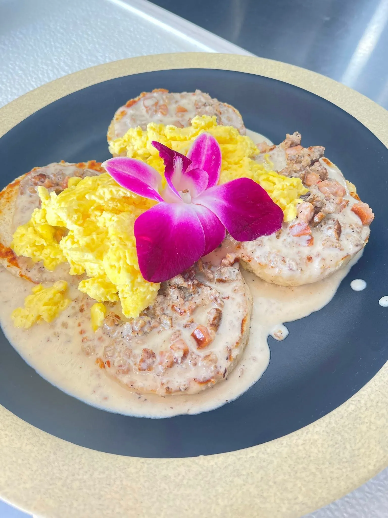 Freshly baked buttermilk biscuits topped with savory sausage gravy and fluffy scrambled eggs.